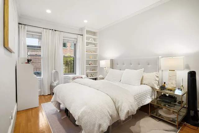 a bedroom with a bed and large window