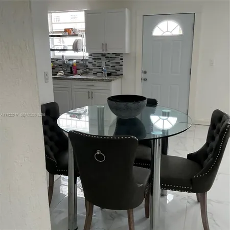 a kitchen with a table and chairs