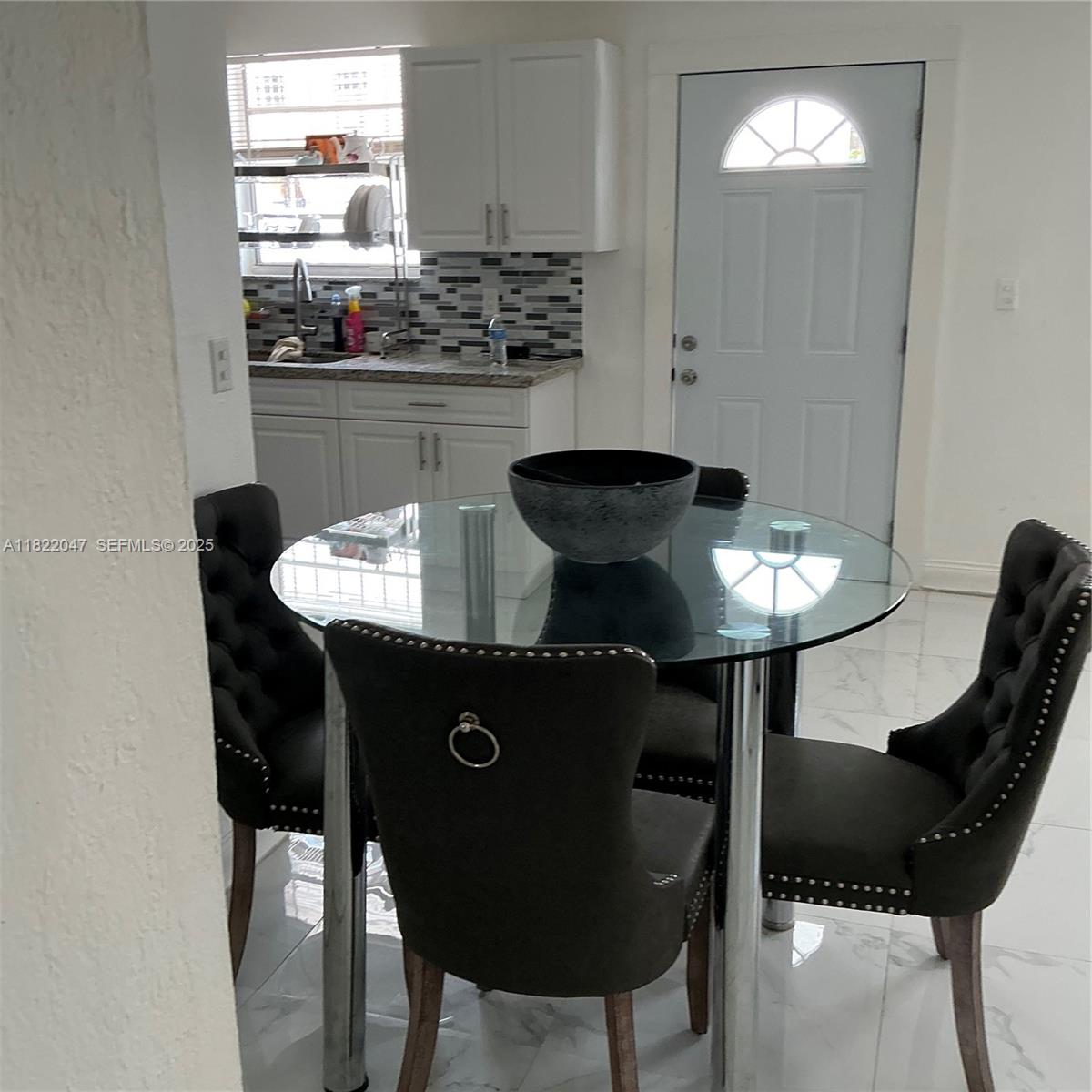 1924 Northwest 35th Street Miami, FL 33142 - Photo 14 of 29 a kitchen with a table and chairs
