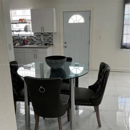 a kitchen with a table and chairs in it