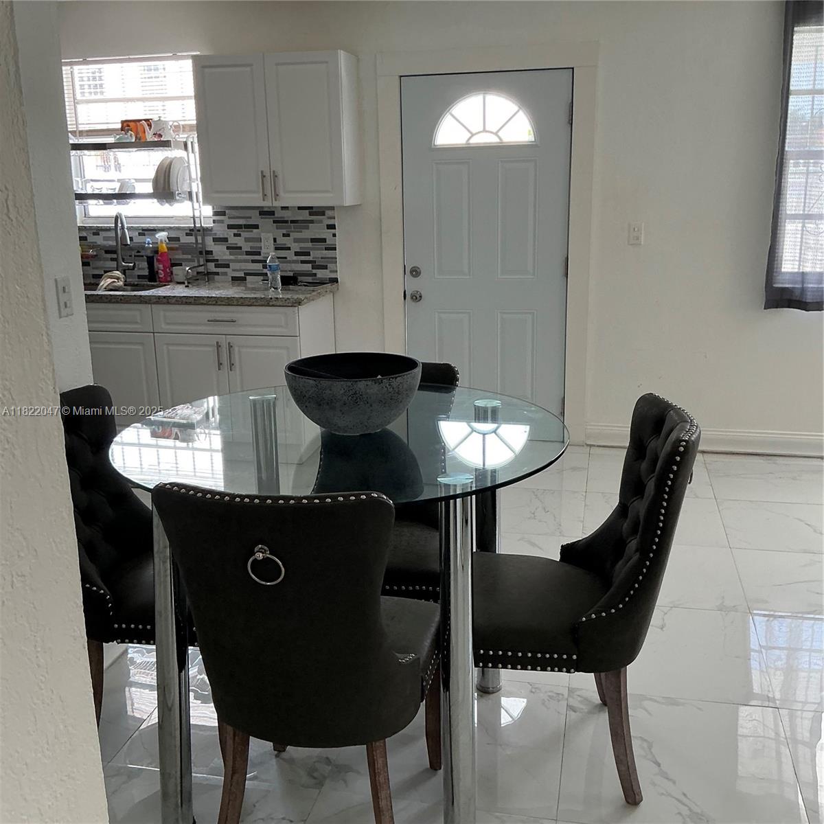 1924 Northwest 35th Street Miami, FL 33142 - Photo 16 of 29 a kitchen with a table and chairs in it