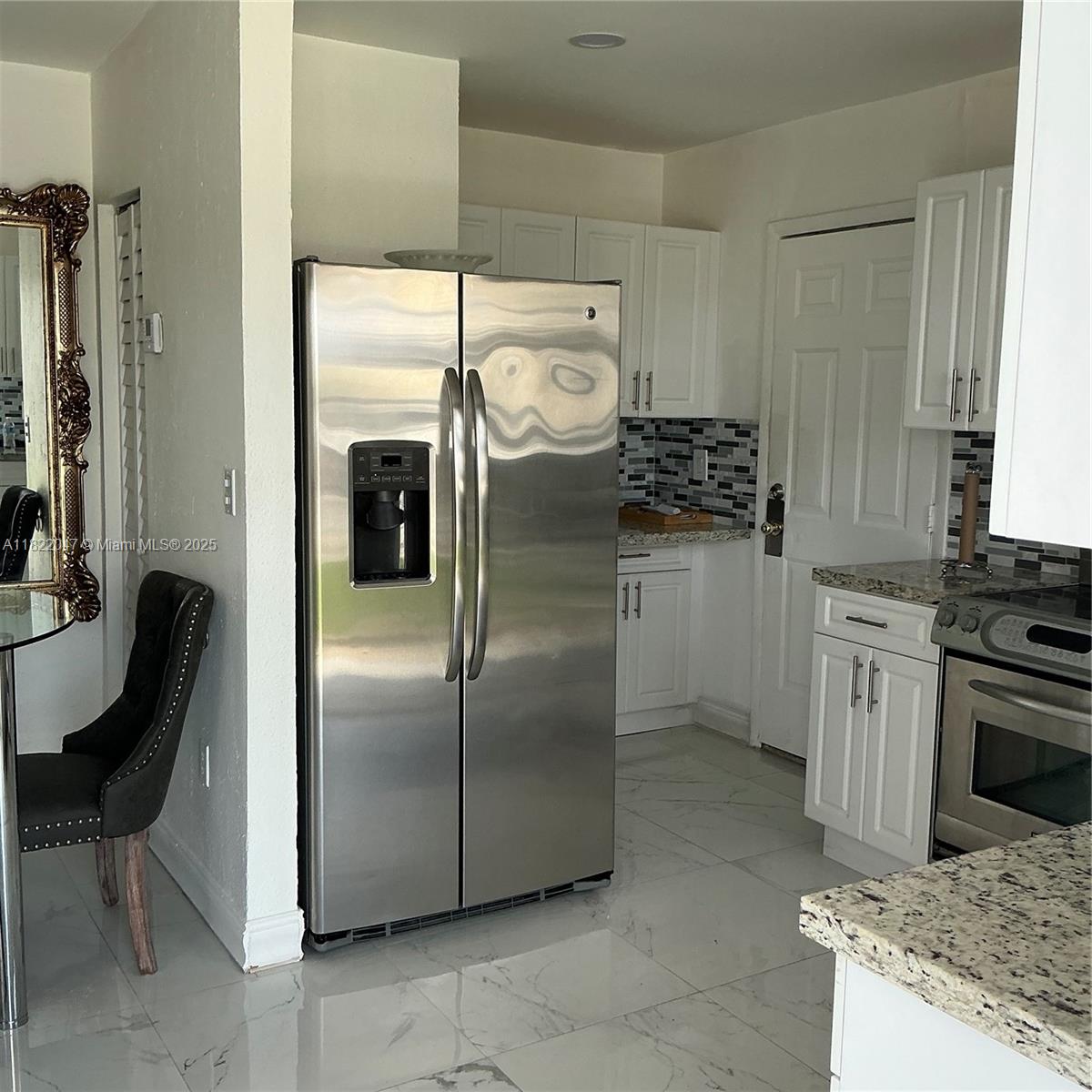 1924 Northwest 35th Street Miami, FL 33142 - Photo 19 of 29 a kitchen with stainless steel appliances granite countertop a refrigerator a stove and a sink with large window