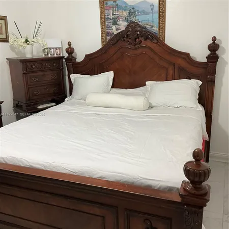 a bedroom with a bed and cabinets