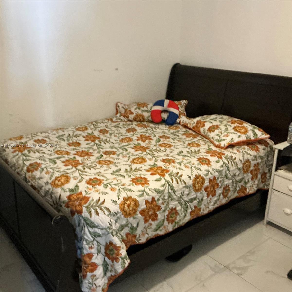 1924 Northwest 35th Street Miami, FL 33142 - Photo 24 of 29 a bed sitting in a bedroom next to a window