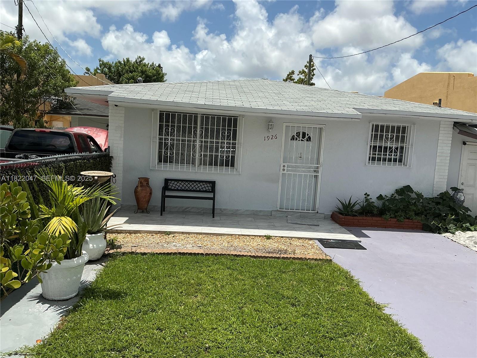1924 Northwest 35th Street Miami, FL 33142 - Photo 4 of 29 a front view of a house with garden