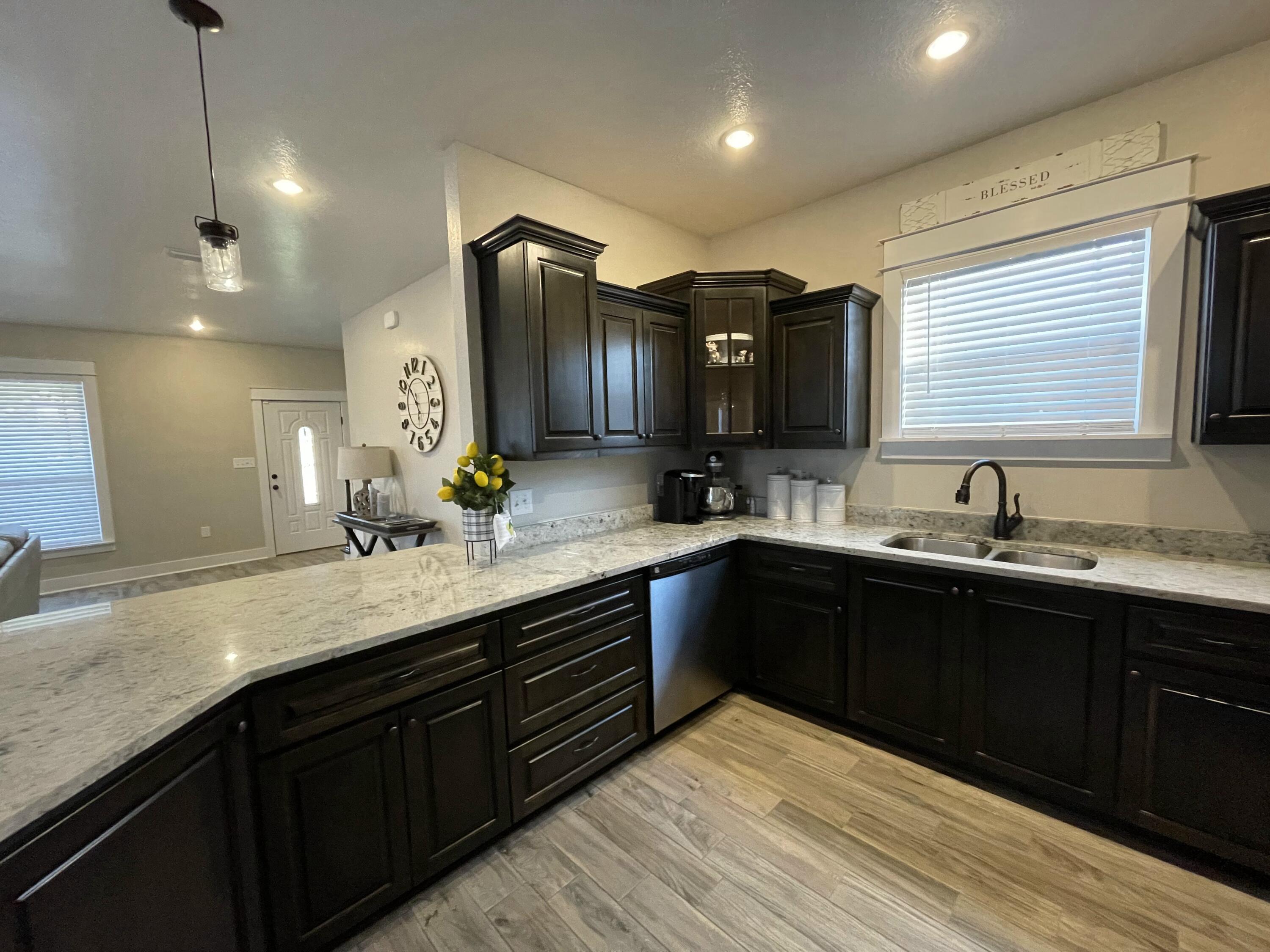 4087 Happy Trails Road Crestview, FL 32539 - Photo 12 of 30 a kitchen with a sink and wooden cabinets