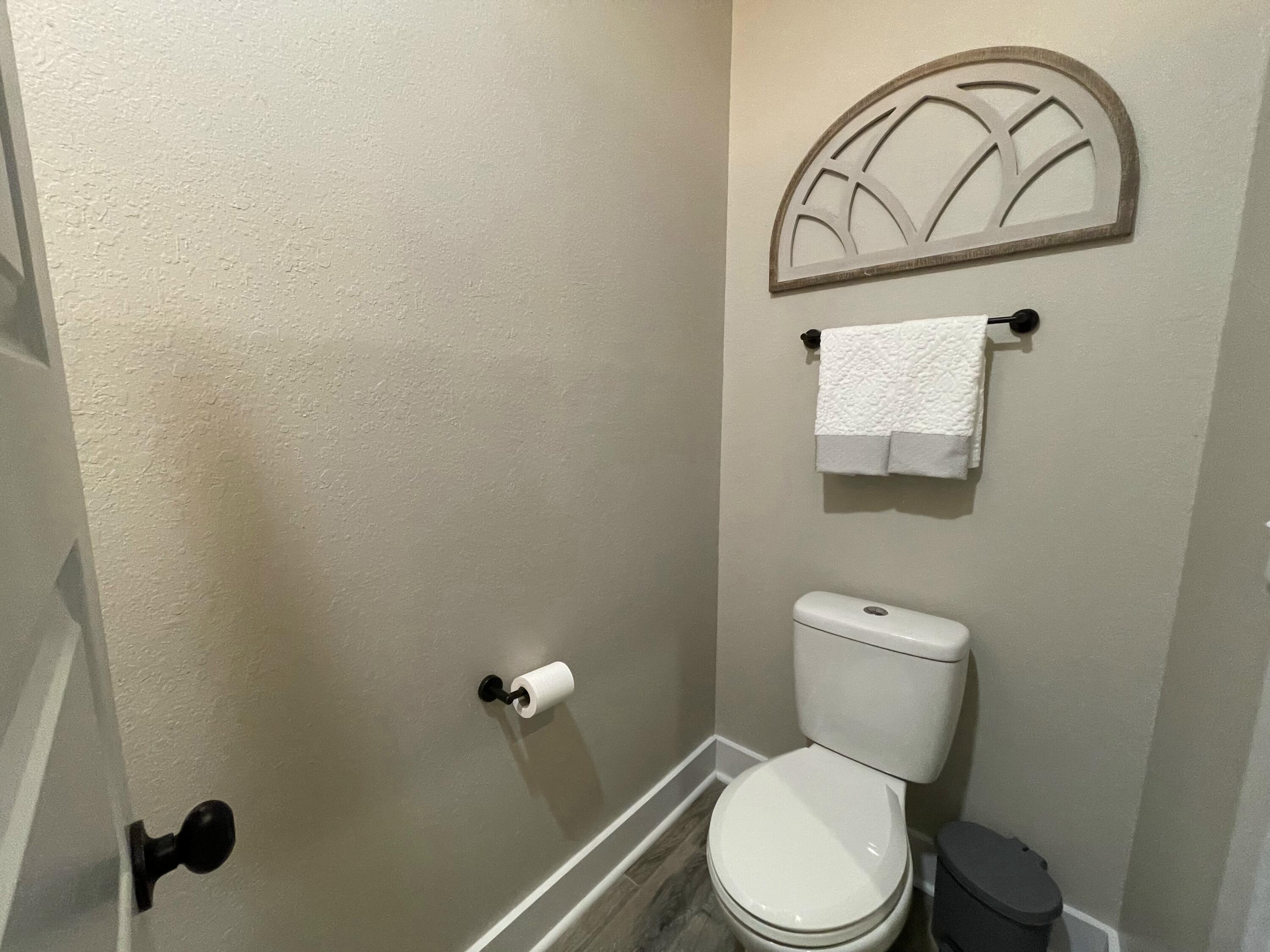 4087 Happy Trails Road Crestview, FL 32539 - Photo 13 of 30 a white toilet sitting next to a bathroom sink