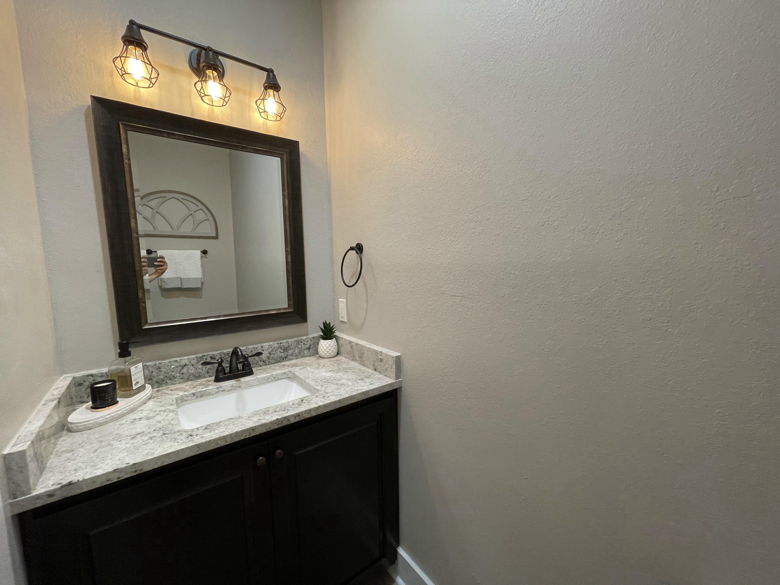4087 Happy Trails Road Crestview, FL 32539 - Photo 14 of 30 a bathroom with a sink vanity and a mirror