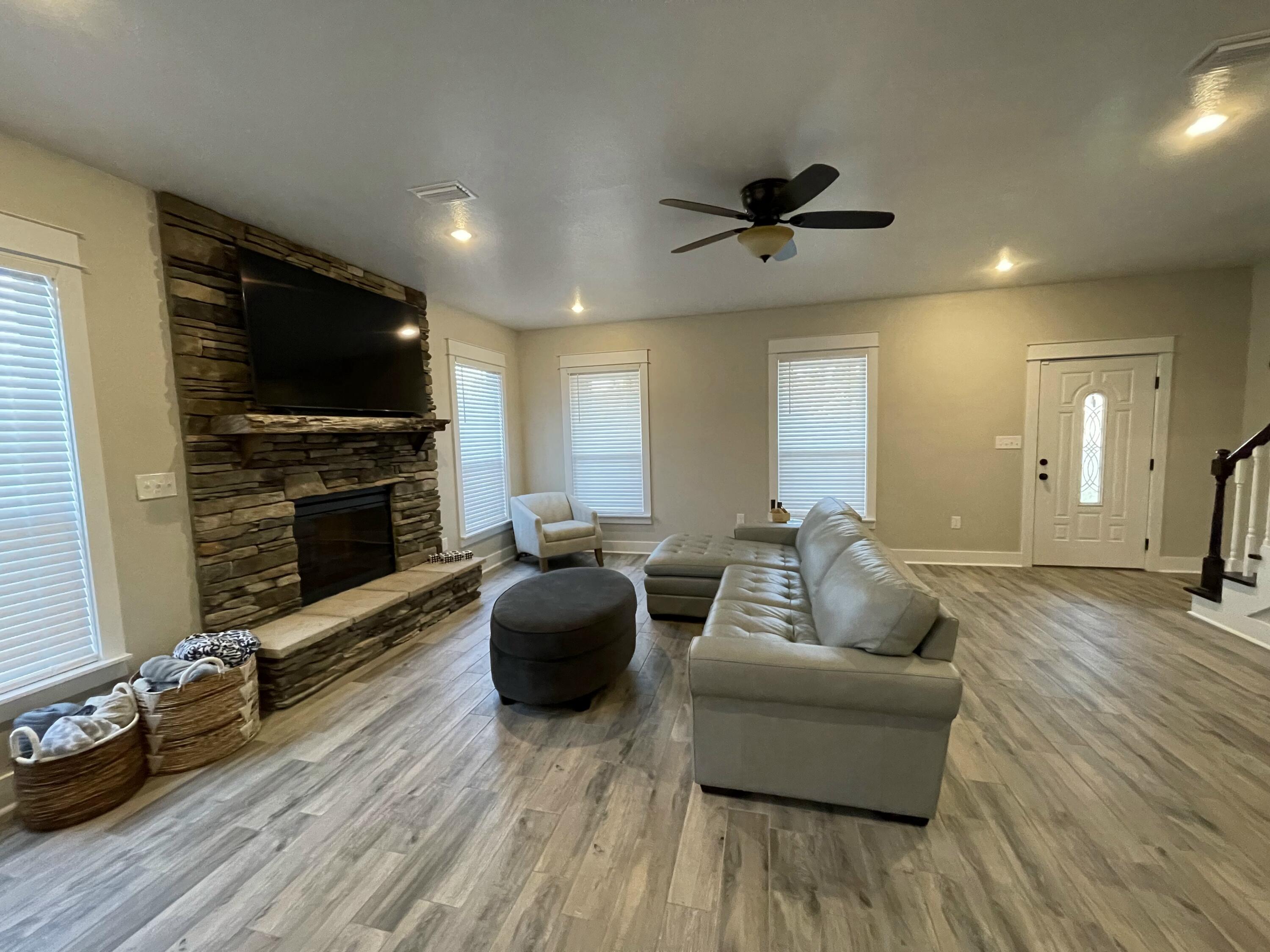 4087 Happy Trails Road Crestview, FL 32539 - Photo 18 of 30 a living room with furniture a flat screen tv and a fireplace
