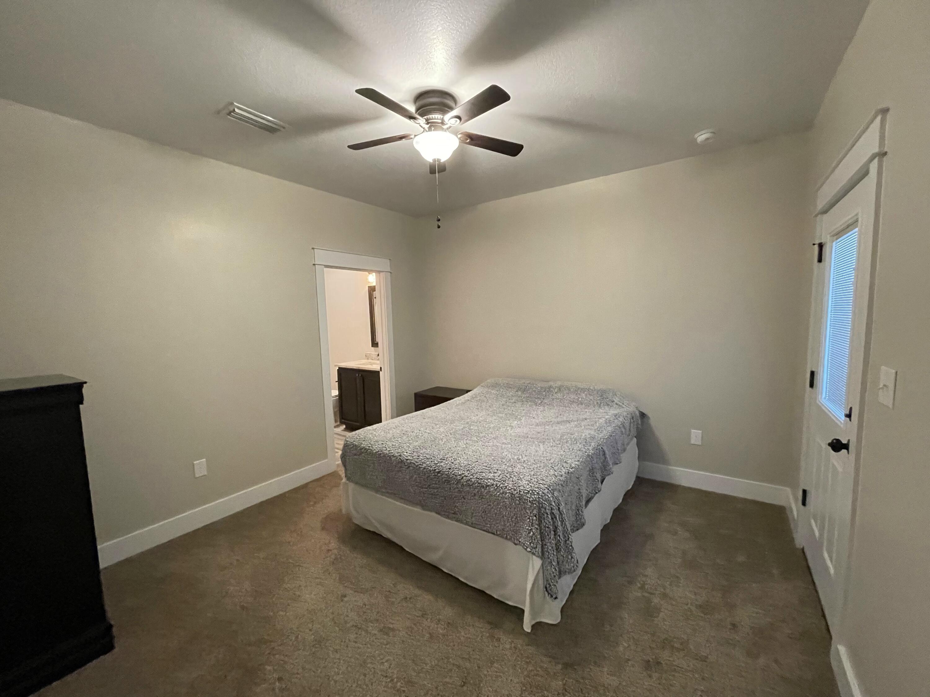 4087 Happy Trails Road Crestview, FL 32539 - Photo 23 of 30 a spacious bedroom with a bed and a ceiling fan