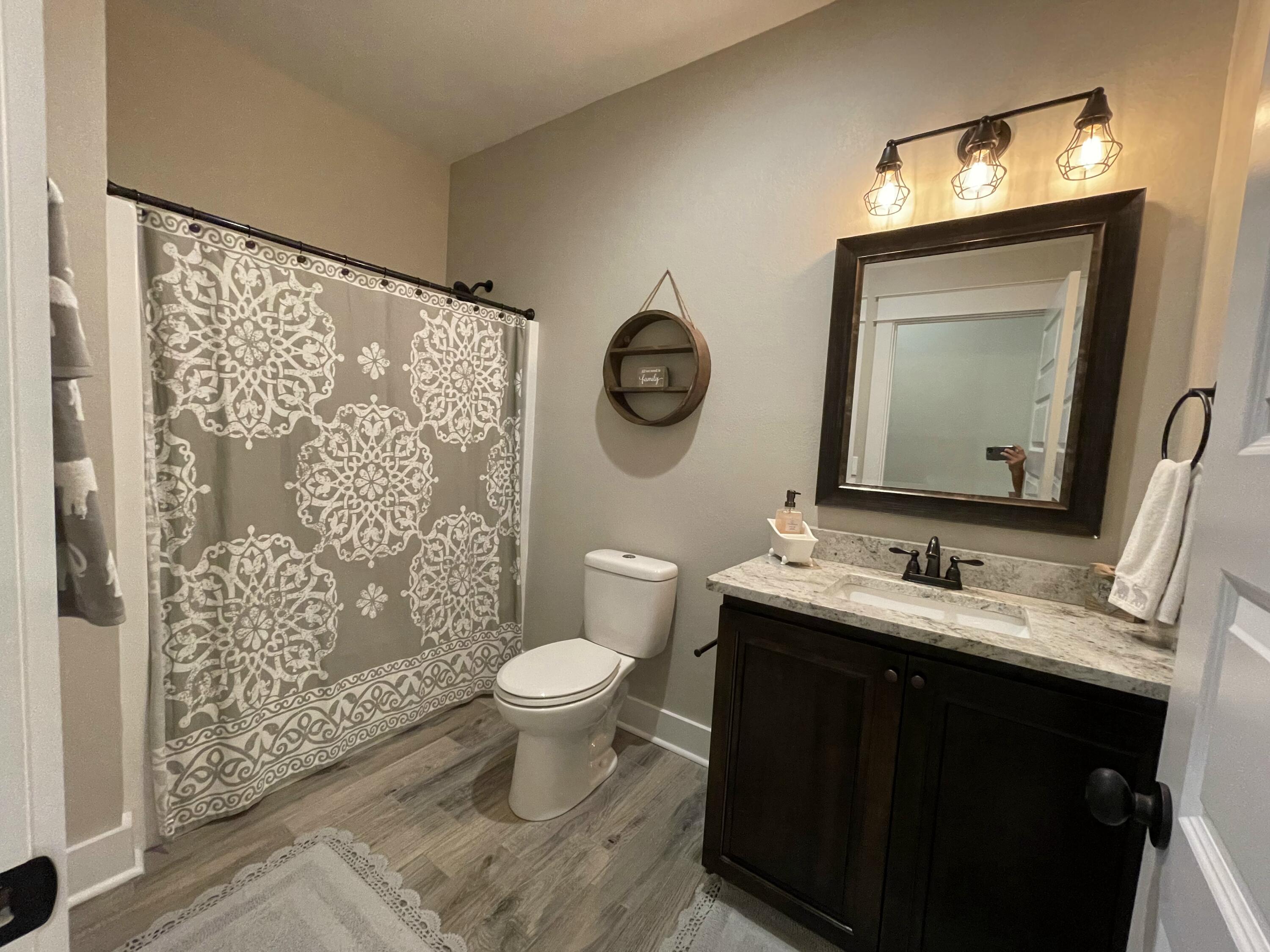 4087 Happy Trails Road Crestview, FL 32539 - Photo 24 of 30 a bathroom with a toilet sink and mirror