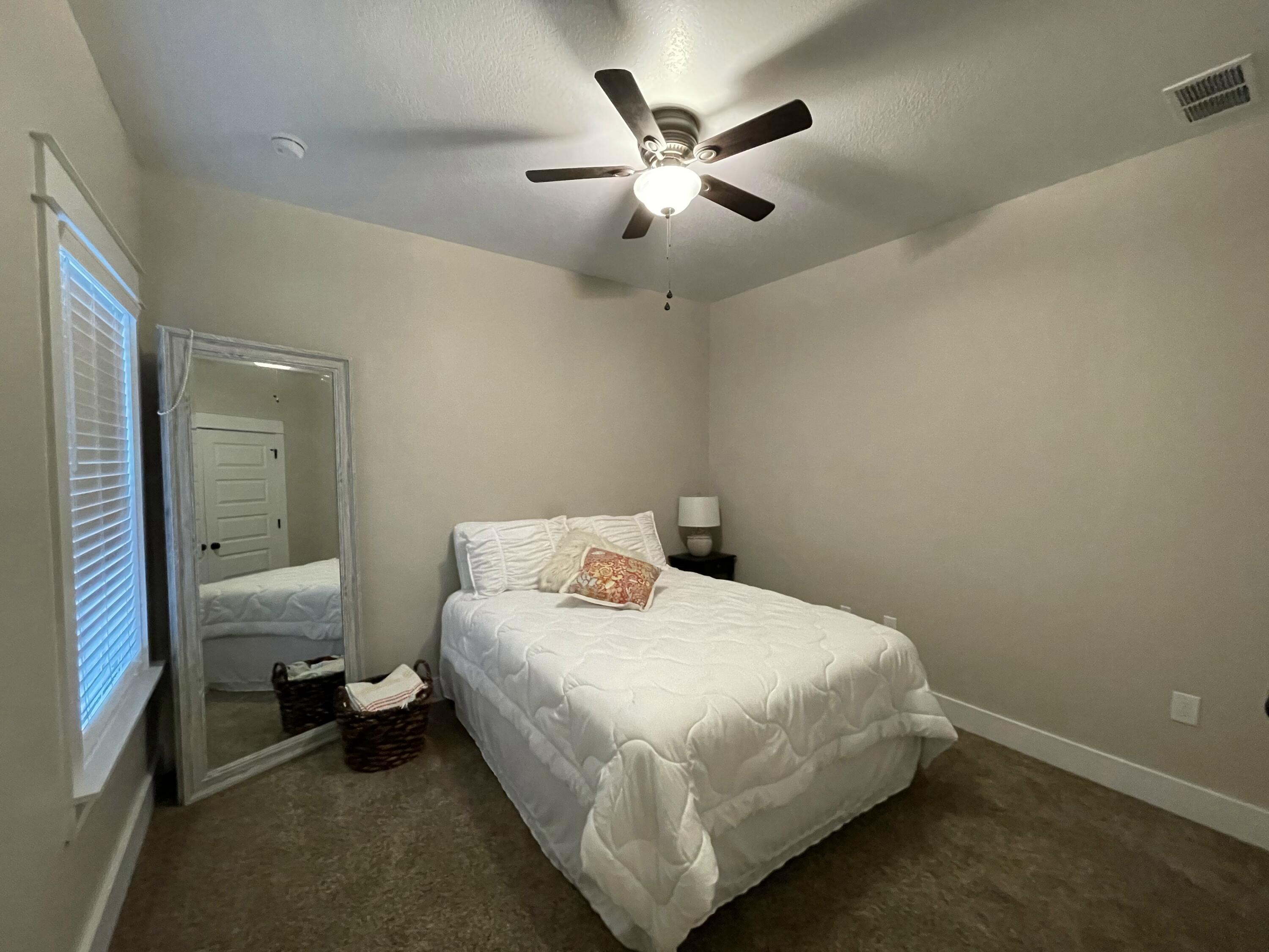 4087 Happy Trails Road Crestview, FL 32539 - Photo 25 of 30 a bedroom with a bed and a chandelier