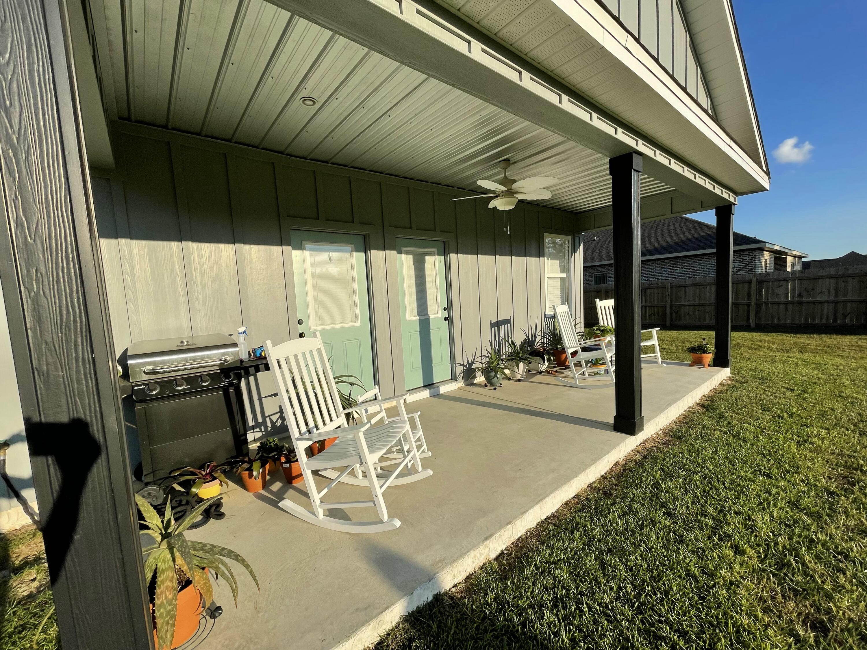 4087 Happy Trails Road Crestview, FL 32539 - Photo 6 of 30 a view of a patio with a table and chairs