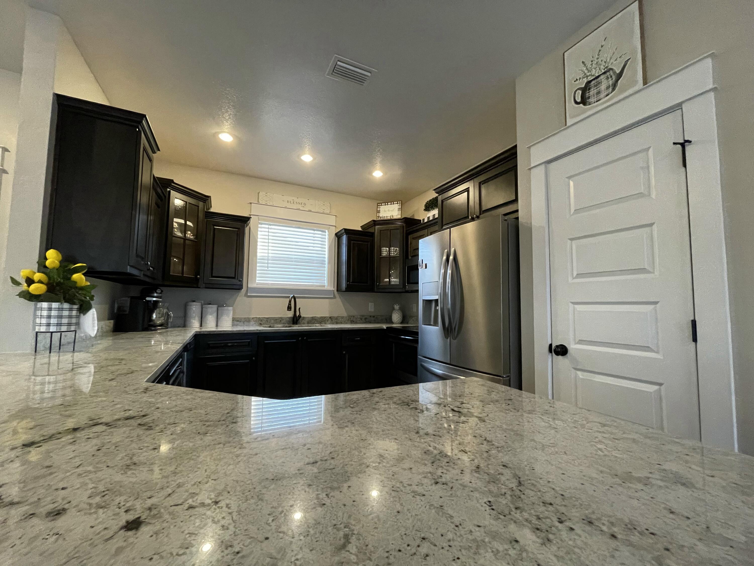 4087 Happy Trails Road Crestview, FL 32539 - Photo 10 of 30 a kitchen with granite countertop a refrigerator and a sink