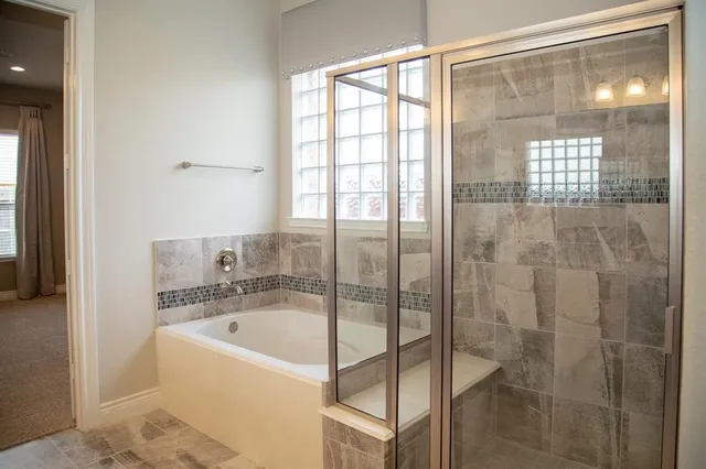 a bathroom with a bathtub and shower