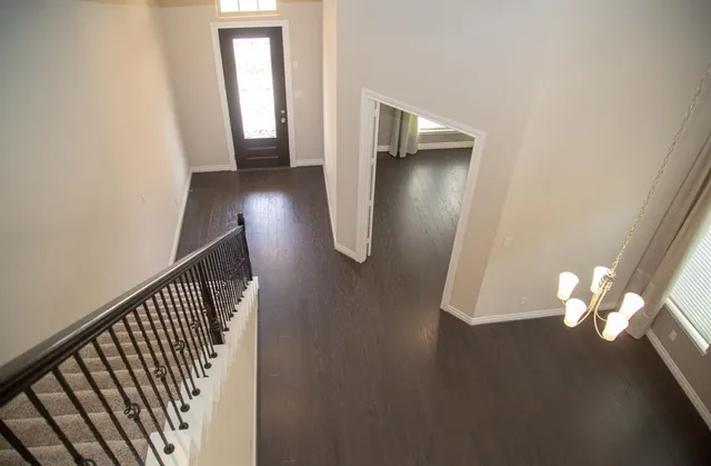 an entryway in a hall with wooden floor