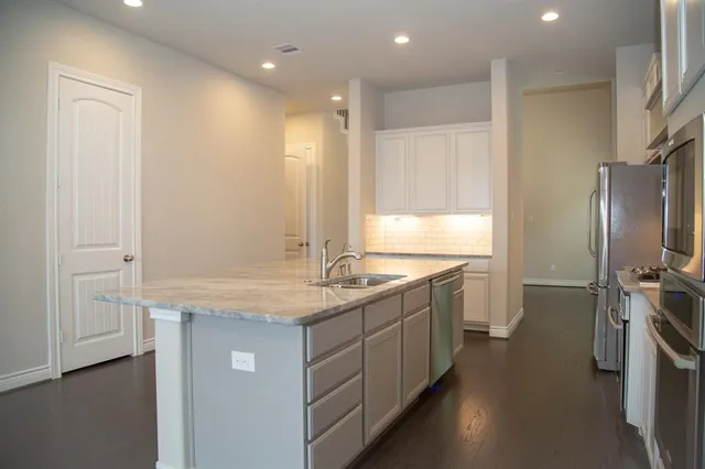 a bathroom with a granite countertop sink a large mirror and a shower