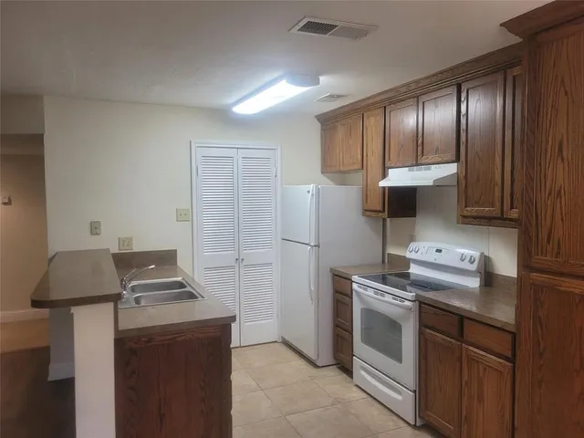 a kitchen with stainless steel appliances granite countertop a stove and a refrigerator