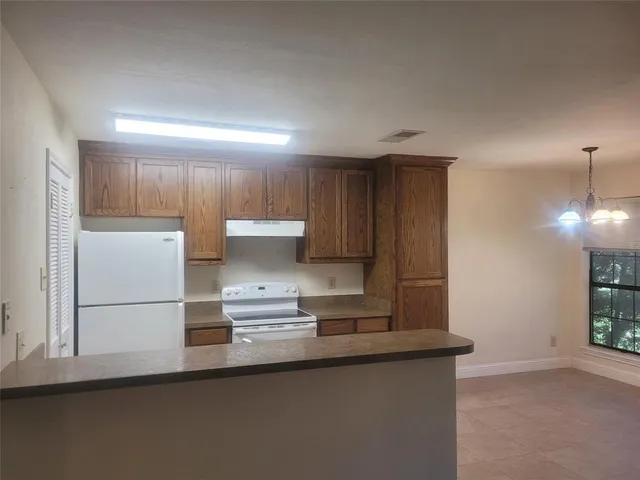 a kitchen with kitchen island a sink appliances and cabinets