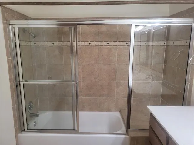 a bathroom with a glass shower door