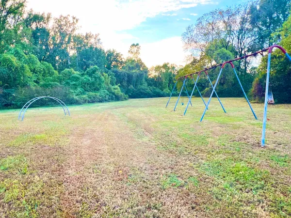 a view of pool with a yard