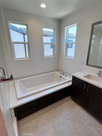a bathroom with a bathtub sink and vanity