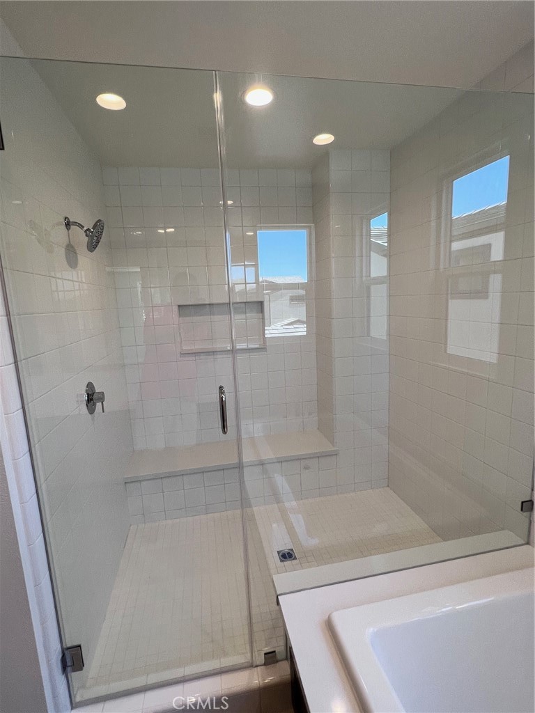 114 Draw Irvine, CA 92618 - Photo 18 of 48 a bathroom with a bathtub and a shower