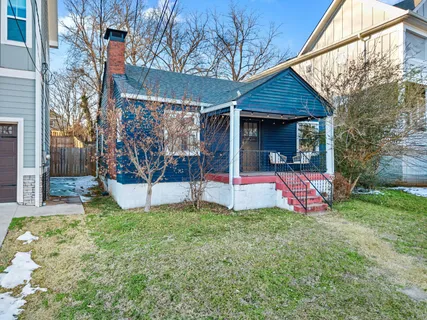 a view of a house with a yard and tree