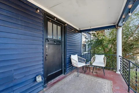 a view of a chairs in backyard of the house
