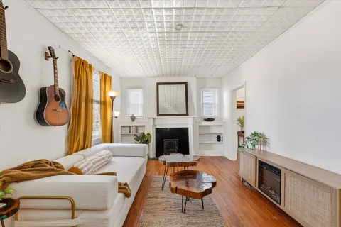 a living room with furniture and a fireplace