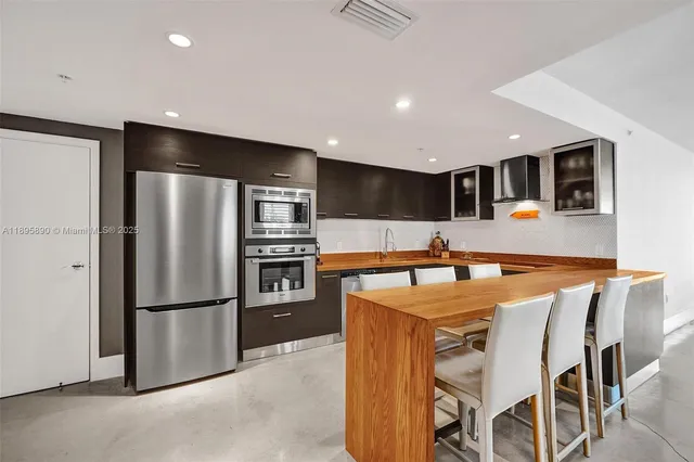 a bedroom with a bed and large windows