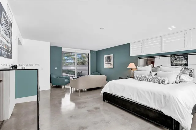 a bedroom with two beds and a large window