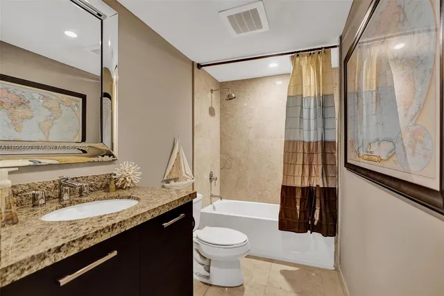 a living room with furniture and floor to ceiling window