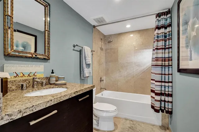 a patio with table and chairs and potted plants