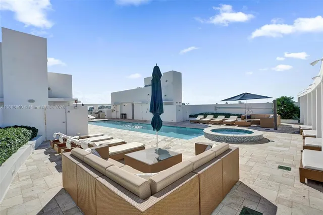 a view of a patio with table and chairs and potted plants