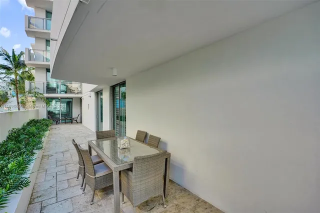 a view of a patio with table and chairs