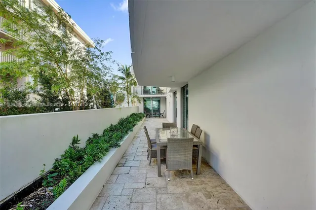 a view of a patio with table and chairs and potted plants