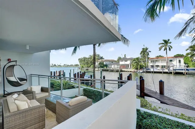 a living room with patio furniture and a potted plant