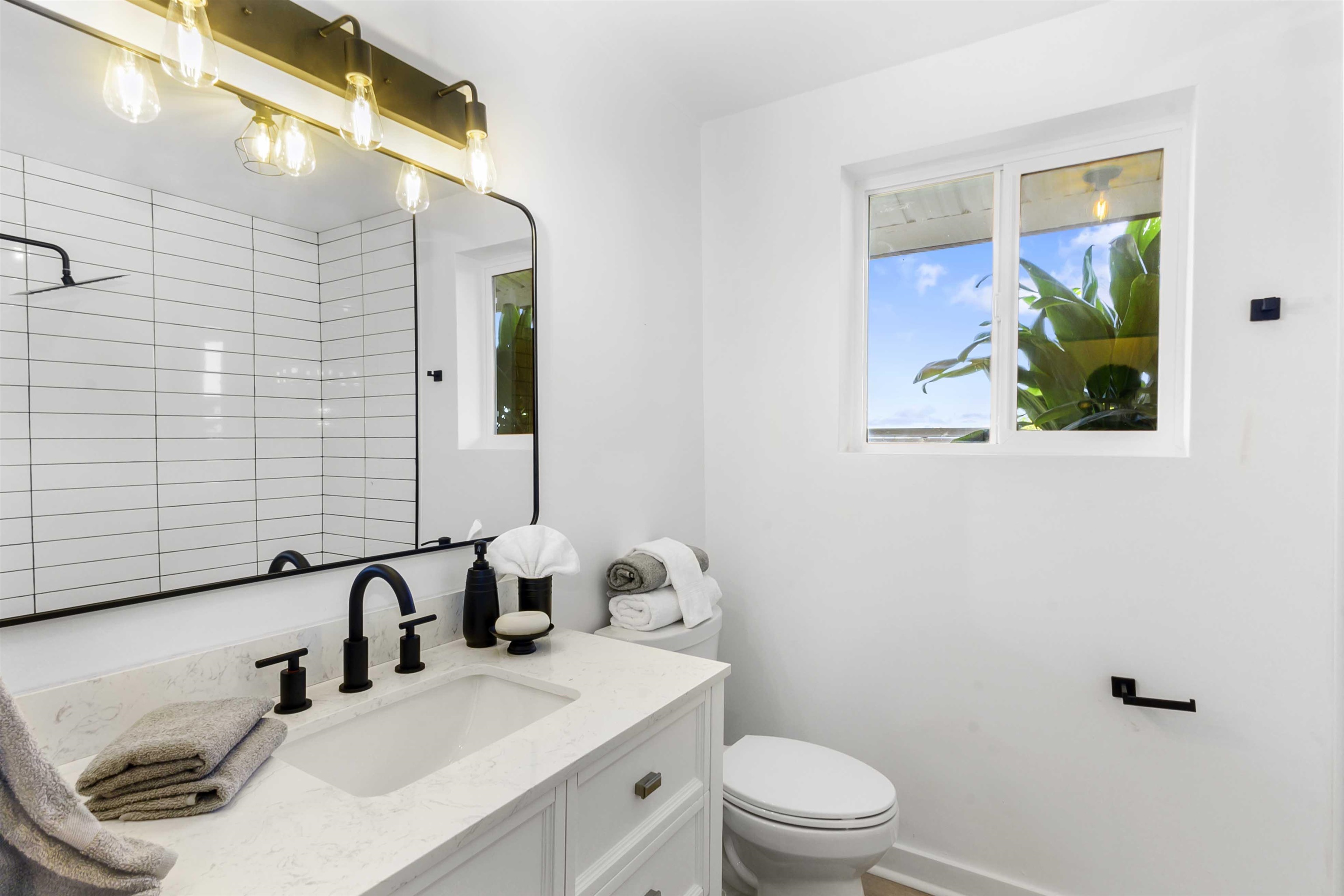 85 Honokaupu Place Haiku, HI 96708 - Photo 9 of 26 a bathroom with a sink a toilet and mirror