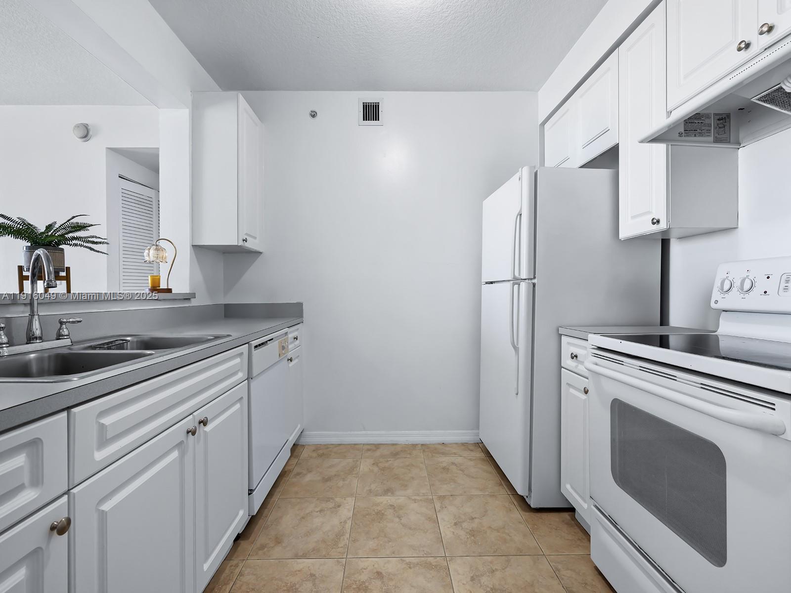 900 Southwest 8th Street, Unit 1208 Miami, FL 33130 - Photo 8 of 26 a kitchen with cabinets appliances and a sink
