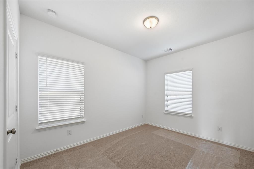 1168 Daybreak Drive, Unit 1168 Allen, TX 75013 - Photo 13 of 25 Wall-to-wall carpeting, two windows with blinds, a flush mount ceiling light, and a white interior door