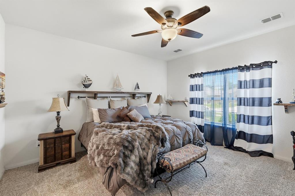 189 Point Rider Road Newark, TX 76071 - Photo 5 of 14 a bedroom with a bed and a chandelier