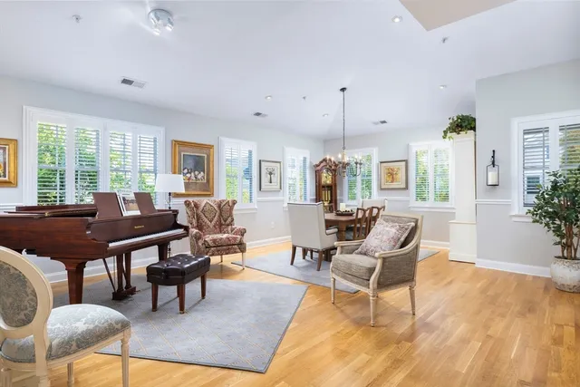 a living room with lots of furniture and a wooden floor