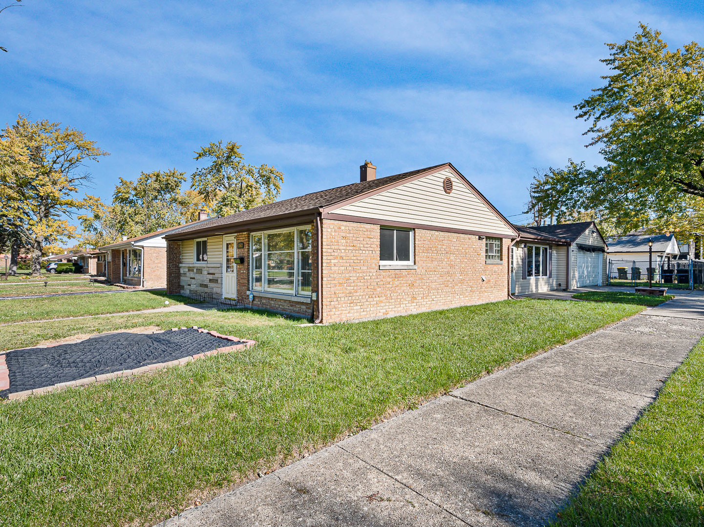 17057 Park Avenue Lansing, IL 60438 - Photo 2 of 17 a front view of a house with a garden