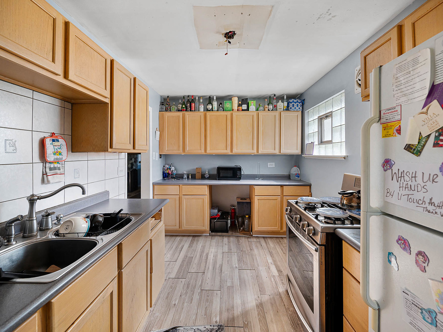17057 Park Avenue Lansing, IL 60438 - Photo 6 of 17 a kitchen with a sink stove top oven and cabinets