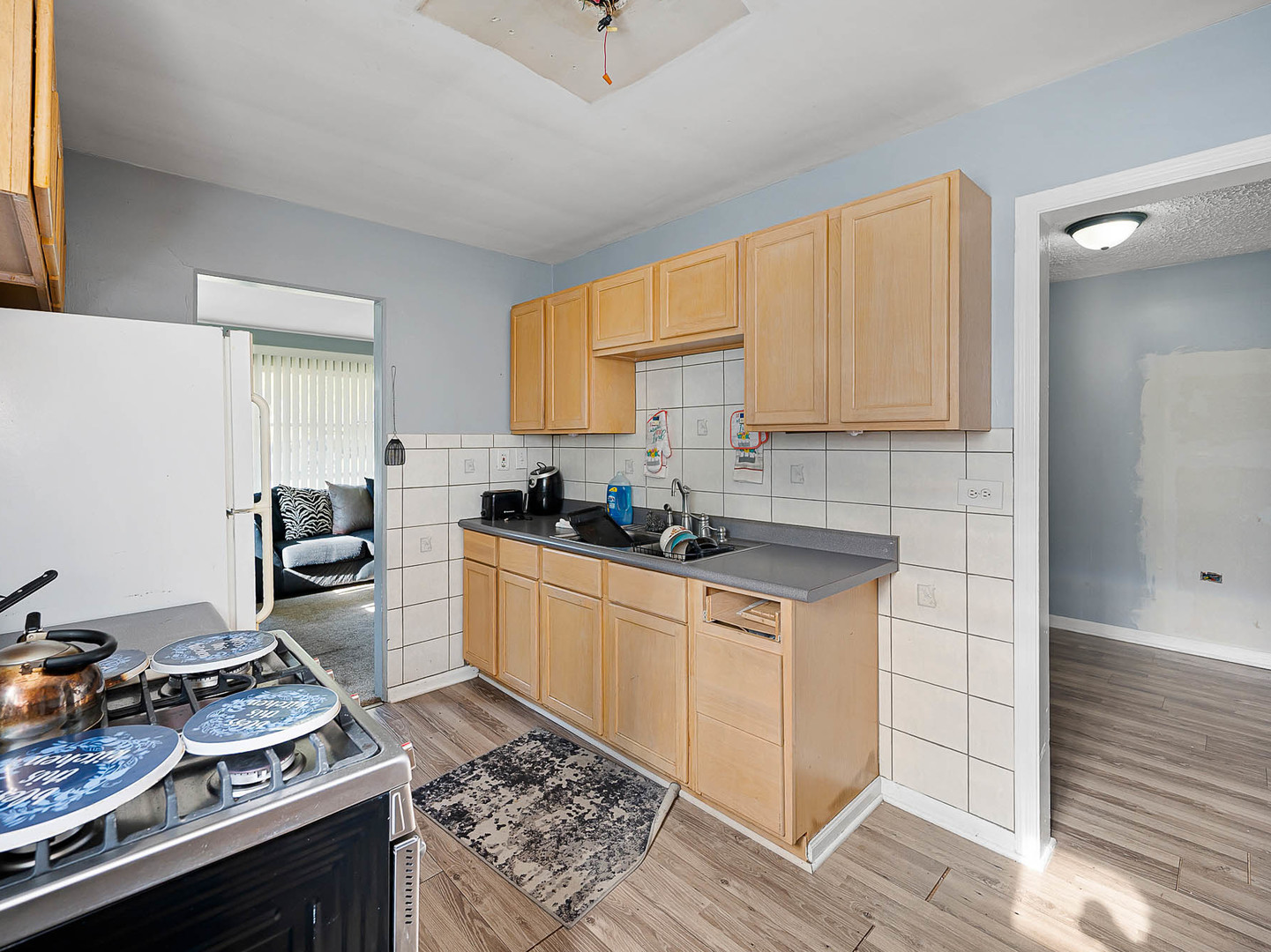 17057 Park Avenue Lansing, IL 60438 - Photo 7 of 17 a kitchen with a stove a sink and a refrigerator
