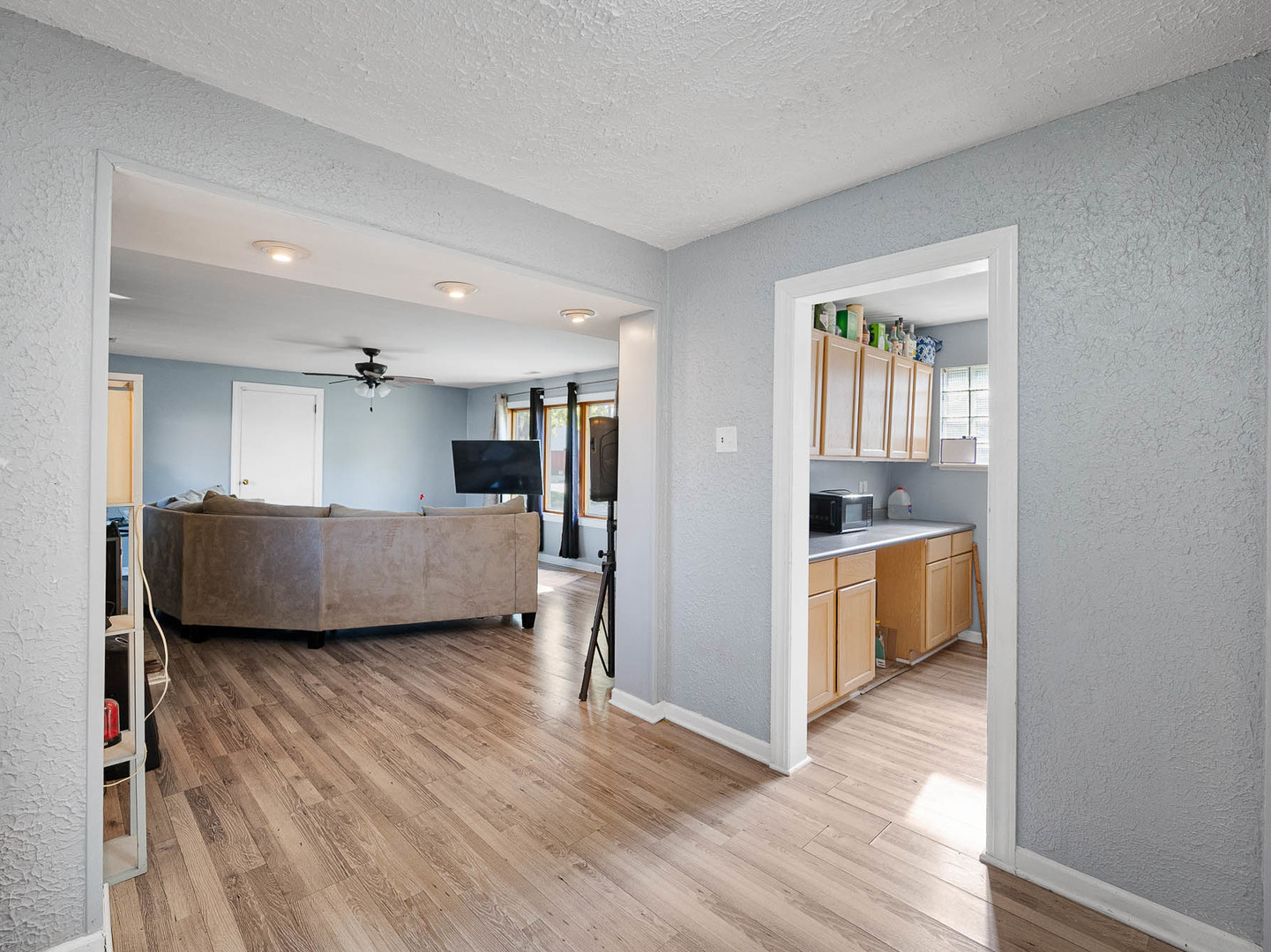 17057 Park Avenue Lansing, IL 60438 - Photo 8 of 17 a view of a living room a kitchen and a wooden floor