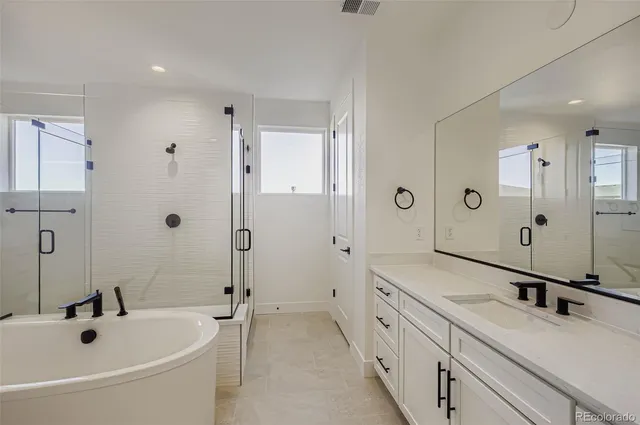 a bathroom with a double vanity sink mirror double and shower