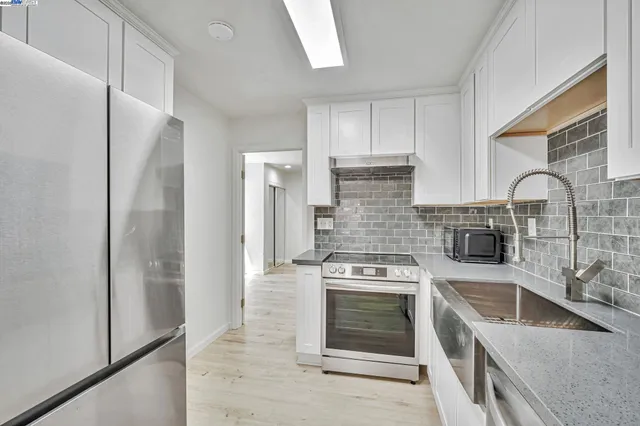 a kitchen with a stove and a refrigerator