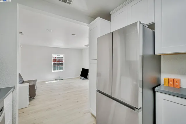 a kitchen with stainless steel appliances a refrigerator and a window